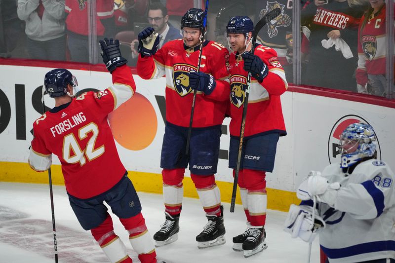 Apr 29, 2024; Sunrise, Florida, USA; Florida Panthers center Aleksander Barkov (16) celebrates a short-handed goal with center Sam Reinhart (13) and defenseman Gustav Forsling (42) against the Tampa Bay Lightning during the second period in game five of the first round of the 2024 Stanley Cup Playoffs at Amerant Bank Arena. Mandatory Credit: Jim Rassol-USA TODAY Sports