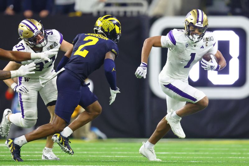 Jan 8, 2024; Houston, TX, USA; Washington Huskies wide receiver Rome Odunze (1) runs with the ball against the Michigan Wolverines during the third quarter in the 2024 College Football Playoff national championship game at NRG Stadium. Mandatory Credit: Mark J. Rebilas-USA TODAY Sports