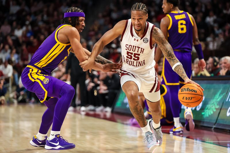 Feb 17, 2024; Columbia, South Carolina, USA; South Carolina Gamecocks guard Ta'Lon Cooper (55) drives around LSU Tigers guard Mike Williams III (2) in the first half at Colonial Life Arena. Mandatory Credit: Jeff Blake-USA TODAY Sports