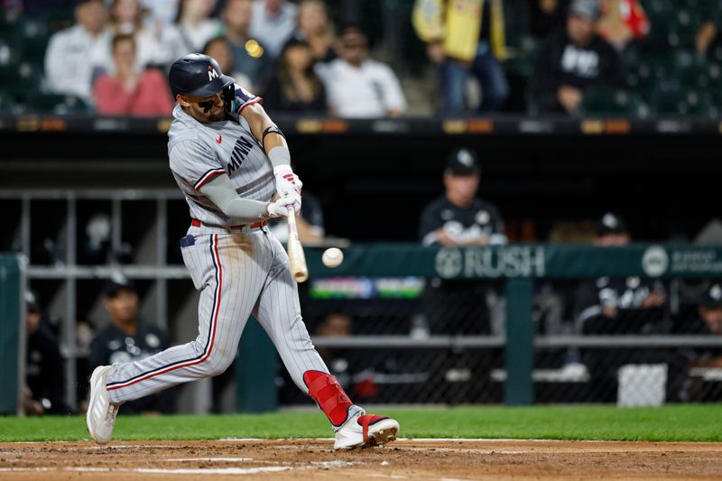 Sep 15, 2023; Chicago, Illinois, USA; Minnesota Twins third baseman Royce Lewis (23) hits a grand slam against the Chicago White Sox during the second inning at Guaranteed Rate Field. Mandatory Credit: Kamil Krzaczynski-USA TODAY Sports