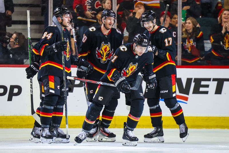 Mar 12, 2024; Calgary, Alberta, CAN; Calgary Flames right wing Walker Duehr (71) celebrates his goal with teammates against the Colorado Avalanche during the first period at Scotiabank Saddledome. Mandatory Credit: Sergei Belski-USA TODAY Sports