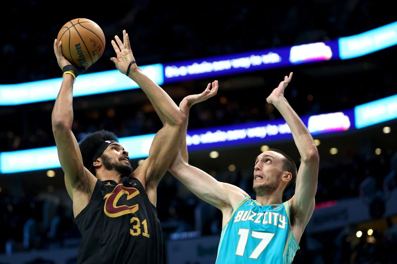 CHARLOTTE, NORTH CAROLINA - MARCH 27: Jarrett Allen #31 of the Cleveland Cavaliers attempts a shot against Aleksej Pokusevski #17 of the Charlotte Hornets during the second half of the game at Spectrum Center on March 27, 2024 in Charlotte, North Carolina. NOTE TO USER: User expressly acknowledges and agrees that, by downloading and or using this photograph, User is consenting to the terms and conditions of the Getty Images License Agreement. (Photo by Jared C. Tilton/Getty Images)