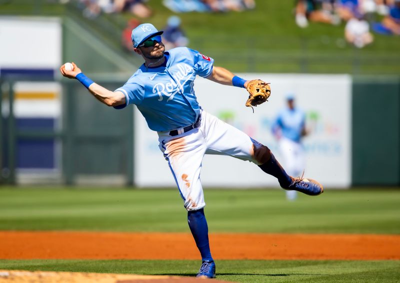 Mar 21, 2024; Surprise, Arizona, USA; Kansas City Royals infielder Garrett Hampson fields a ground ball for an out against the Chicago White Sox during a spring training baseball game at Surprise Stadium. Mandatory Credit: Mark J. Rebilas-USA TODAY Sports