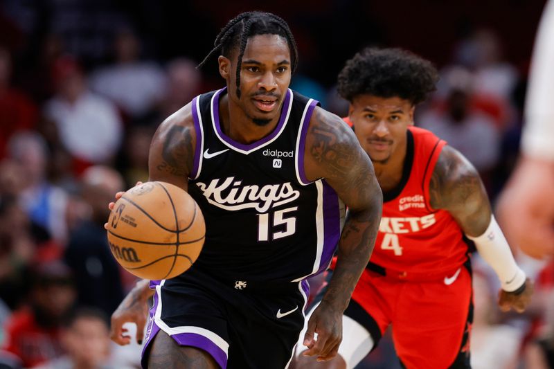 HOUSTON, TEXAS - NOVEMBER 06: Davion Mitchell #15 of the Sacramento Kings controls the ball ahead of Jalen Green #4 of the Houston Rockets during the first half at Toyota Center on November 06, 2023 in Houston, Texas. (Photo by Carmen Mandato/Getty Images)