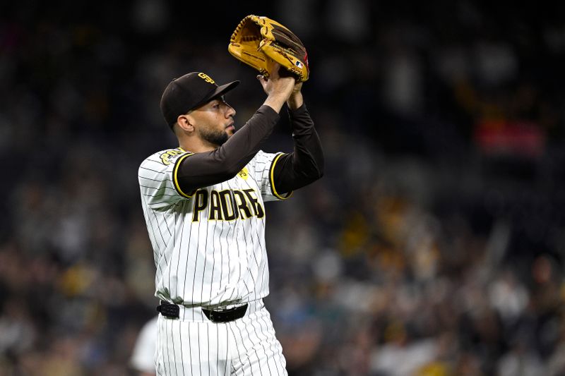 Jun 11, 2024; San Diego, California, USA; San Diego Padres relief pitcher Robert Suarez (75) applauds after a catch by second baseman Jake Cronenworth (not pictured) to end the top of the ninth inning against the Oakland Athletics at Petco Park. Mandatory Credit: Orlando Ramirez-USA TODAY Sports