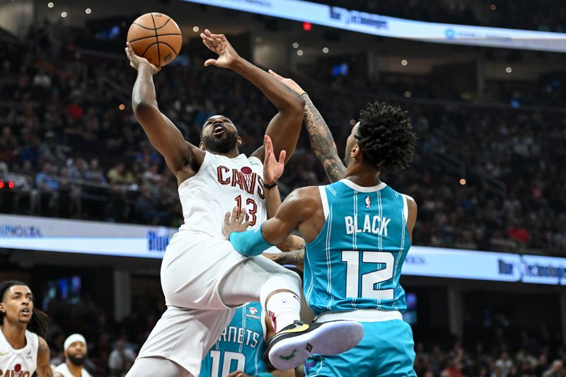 CLEVELAND, OHIO - APRIL 14: Tristan Thompson #13 of the Cleveland Cavaliers shoots against Leaky Black #12 of the Charlotte Hornets during the first half at Rocket Mortgage Fieldhouse on April 14, 2024 in Cleveland, Ohio. NOTE TO USER: User expressly acknowledges and agrees that, by downloading and or using this photograph, User is consenting to the terms and conditions of the Getty Images License Agreement. (Photo by Nick Cammett/Getty Images)