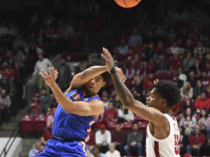 Feb 21, 2024; Tuscaloosa, Alabama, USA;  Florida Gators forward Zyon Pullin (0) passes to the corner over Alabama Crimson Tide guard Aaron Estrada at Coleman Coliseum. Mandatory Credit: Gary Cosby Jr.-USA TODAY Sports