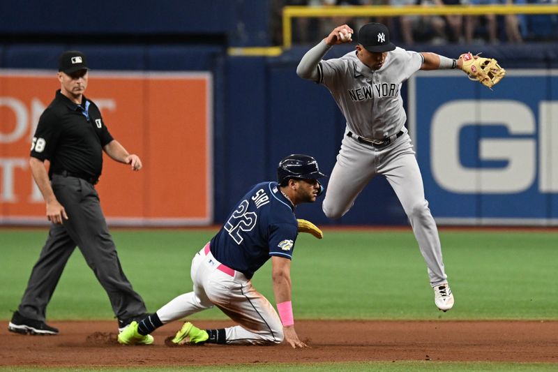 Aug 26, 2023; St. Petersburg, Florida, USA; New York Yankees shortstop Oswaldo Peraza (91) attempts to turn a double play as Tampa Bay Rays center fielder Jose Siri (22) slides in the seventh inning at Tropicana Field. Mandatory Credit: Jonathan Dyer-USA TODAY Sports