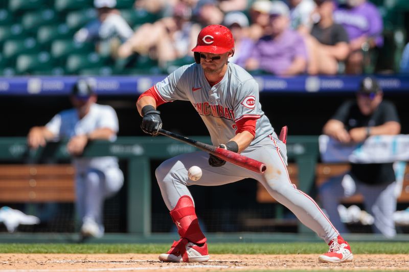 Jun 5, 2024; Denver, Colorado, USA; Cincinnati Reds outfielder TJ Friedl (29) bunts the ball during the seventh inning against the Colorado Rockies at Coors Field. Mandatory Credit: Andrew Wevers-USA TODAY Sports