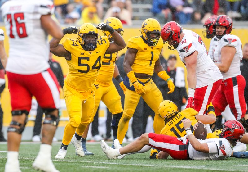 Sep 23, 2023; Morgantown, West Virginia, USA; West Virginia Mountaineers defensive lineman Fatorma Mulbah (54) celebrates after a defensive stop against the Texas Tech Red Raiders during the third quarter at Mountaineer Field at Milan Puskar Stadium. Mandatory Credit: Ben Queen-USA TODAY Sports