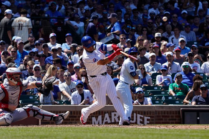 Aug 7, 2024; Chicago, Illinois, USA; Chicago Cubs third baseman Isaac Paredes (17) hits a  sacrifice to drive in a run against the Minnesota Twins during the third inning at Wrigley Field. Mandatory Credit: David Banks-USA TODAY Sports