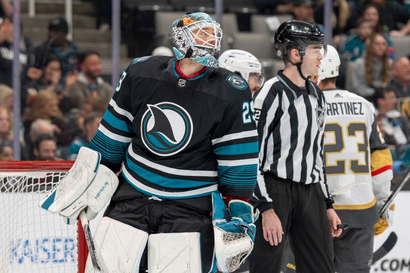 Feb 19, 2024; San Jose, California, USA; San Jose Sharks goalie Mackenzie Blackwood (29) looks at the replay of the goal scored by Vegas Golden Knights center William Karlsson (not pictured) during the first period at SAP Center at San Jose. Mandatory Credit: Neville E. Guard-USA TODAY Sports