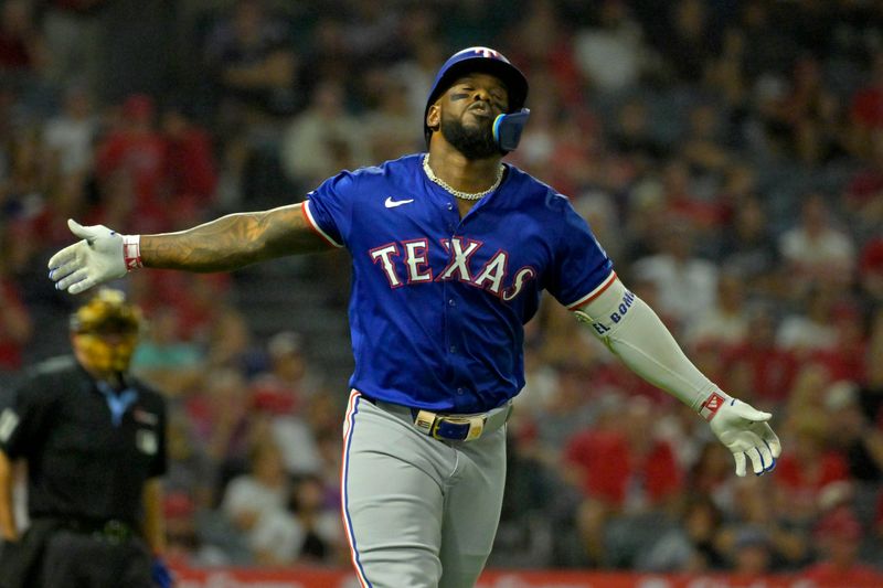 Jul 9, 2024; Anaheim, California, USA;  Texas Rangers left fielder Adolis Garcis (53) celebrates after hitting a solo home run in the eighth inning against the Los Angeles Angels at Angel Stadium. Mandatory Credit: Jayne Kamin-Oncea-USA TODAY Sports