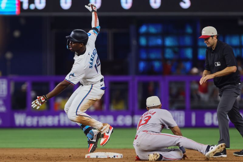 Jul 4, 2024; Miami, Florida, USA; Miami Marlins right fielder Jesus Sanchez (12) slides at second base after hitting a double against the Boston Red Sox during the ninth inning at loanDepot Park. Mandatory Credit: Sam Navarro-USA TODAY Sports