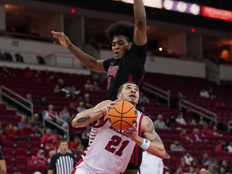 Feb 14, 2024; Fresno, California, USA; Fresno State Bulldogs guard Isaiah Pope (21) drives past UNLV Rebels forward Rob Whaley Jr. (5) in the second half at the Save Mart Center. Mandatory Credit: Cary Edmondson-USA TODAY Sports