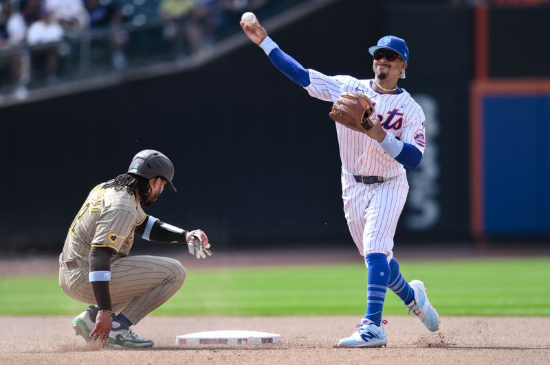 Jun 16, 2024; New York City, New York, USA; New York Mets shortstop Francisco Lindor (12) gets a force out at second base against San Diego Padres catcher Luis Campusano (12) and throws to first base to complete a double play during the seventh inning at Citi Field. Mandatory Credit: John Jones-USA TODAY Sports