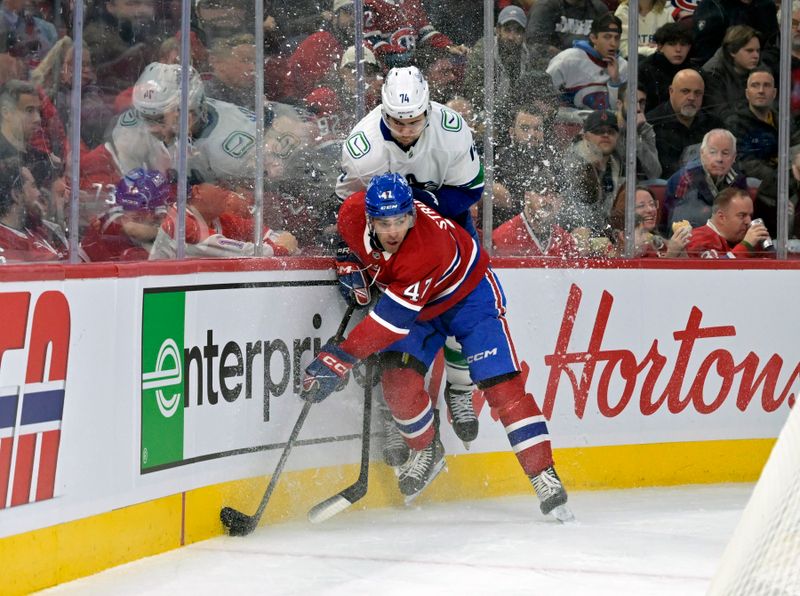 Jan 6, 2025; Montreal, Quebec, CAN; Montreal Canadiens defenseman Jayden Struble (47) checks Vancouver Canucks forward Jake Debrusk (74) during the first period at the Bell Centre. Mandatory Credit: Eric Bolte-Imagn Images