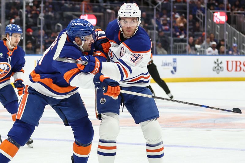 Oct 16, 2025; Elmont, New York, USA; New York Islanders defenseman Adam Pelech (3) collides with Edmonton Oilers center Connor McDavid (97) in the third period at UBS Arena. Mandatory Credit: Wendell Cruz-Imagn Images