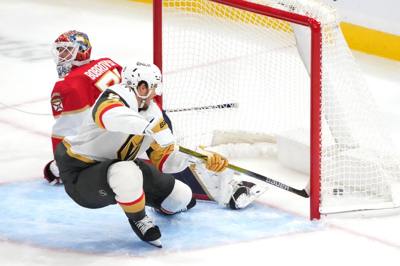 Oct 19, 2024; Sunrise, Florida, USA; Vegas Golden Knights center Brett Howden (21) scores a goal against Florida Panthers goaltender Sergei Bobrovsky (72) during the third period at Amerant Bank Arena. Mandatory Credit: Jim Rassol-Imagn Images