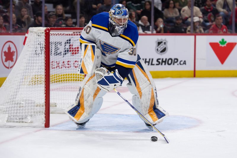 Oct 29, 2024; Ottawa, Ontario, CAN; St. Louis Blues goalie Joel Hofer (30) moves the puck in the first period against the Ottawa Senators at the Canadian Tire Centre. Mandatory Credit: Marc DesRosiers-Imagn Images