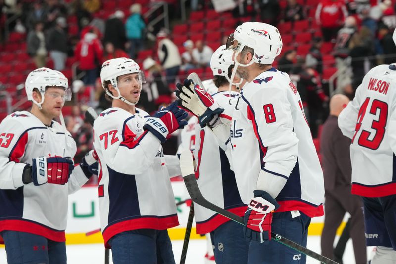 Nov 11, 2025; Raleigh, North Carolina, USA;  Washington Capitals left wing Alex Ovechkin (8) and left wing Anthony Beauvillier (72) celebrate their victory against the Carolina Hurricanes at Lenovo Center. Mandatory Credit: James Guillory-Imagn Images