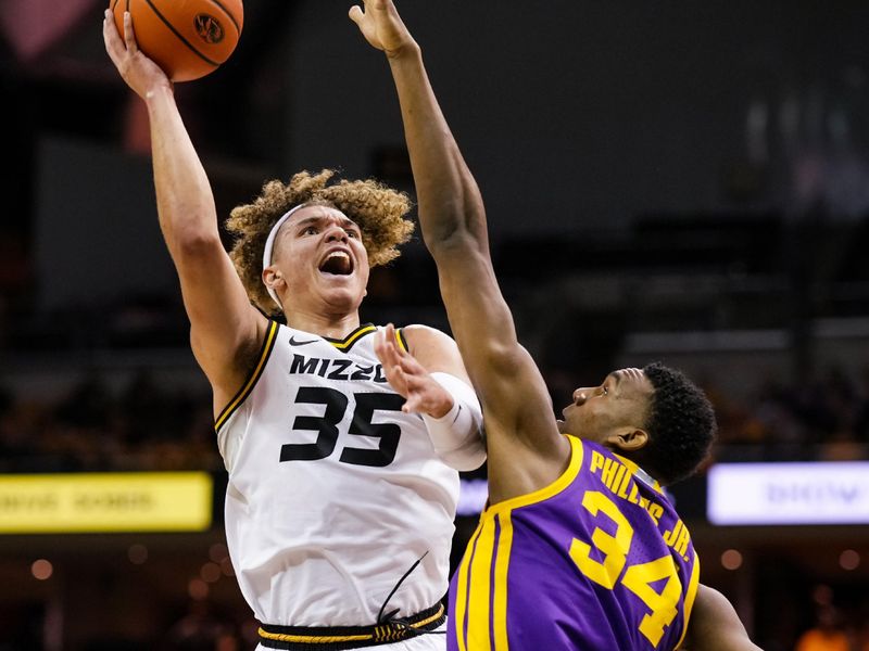 Feb 1, 2023; Columbia, Missouri, USA; Missouri Tigers forward Noah Carter (35) shoots against LSU Tigers forward Shawn Phillips (34) during the first half at Mizzou Arena. Mandatory Credit: Jay Biggerstaff-USA TODAY Sports