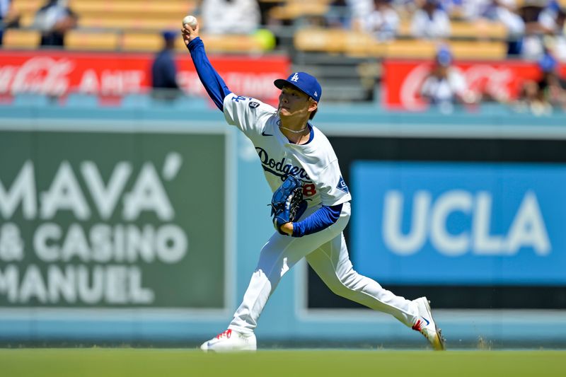 Aug 31, 2025; Los Angeles, California, USA; Los Angeles Dodgers starting pitcher Yoshinobu Yamamoto (18) warming up in the outfield at Dodger Stadium. Mandatory Credit: Jayne Kamin-Oncea-Imagn Images