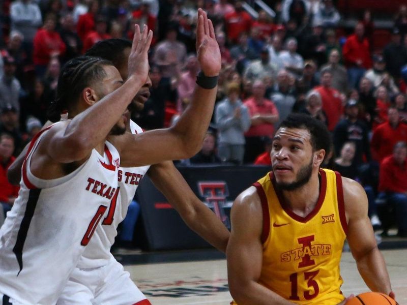 Jan 30, 2023; Lubbock, Texas, USA;  Iowa State Cyclones guard Jaren Holmes (13) looks to shoot the ball against Texas Tech Red Raiders forward Kevin Obanor (0) and guard Lamar Washington (1) in overtime at United Supermarkets Arena. Mandatory Credit: Michael C. Johnson-USA TODAY Sports