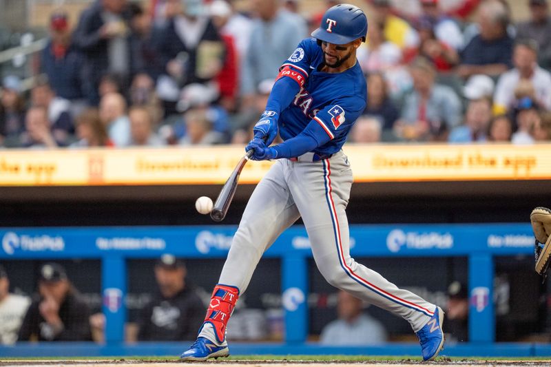 May 24, 2024; Minneapolis, Minnesota, USA; Texas Rangers center fielder Leody Taveras (3) connects against Minnesota Twins pitcher Bailey Ober (17) in the first inning at Target Field. Mandatory Credit: Matt Blewett-USA TODAY Sports