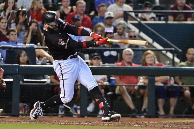 Jul 26, 2023; Phoenix, Arizona, USA;  Arizona Diamondbacks third baseman Emmanuel Rivera (15) hits a solo home run in the sixth inning against the St. Louis Cardinals at Chase Field. Mandatory Credit: Matt Kartozian-USA TODAY Sports