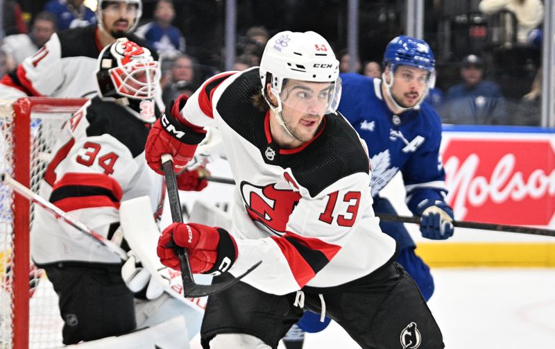 Apr 11, 2024; Toronto, Ontario, CAN; New Jersey Devils forward Nico Hischier (13) pursues the play against the Toronto Maple Leafs in the third period at Scotiabank Arena. Mandatory Credit: Dan Hamilton-USA TODAY Sports