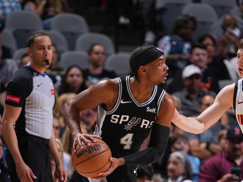 SAN ANTONIO, TX - APRIL 12: Devonte Graham #4 of the San Antonio Spurs looks to pass the ball during the game against the Denver Nuggets on April 12, 2024 at the Frost Bank Center in San Antonio, Texas. NOTE TO USER: User expressly acknowledges and agrees that, by downloading and or using this photograph, user is consenting to the terms and conditions of the Getty Images License Agreement. Mandatory Copyright Notice: Copyright 2024 NBAE (Photos by Garrett Ellwood/NBAE via Getty Images)