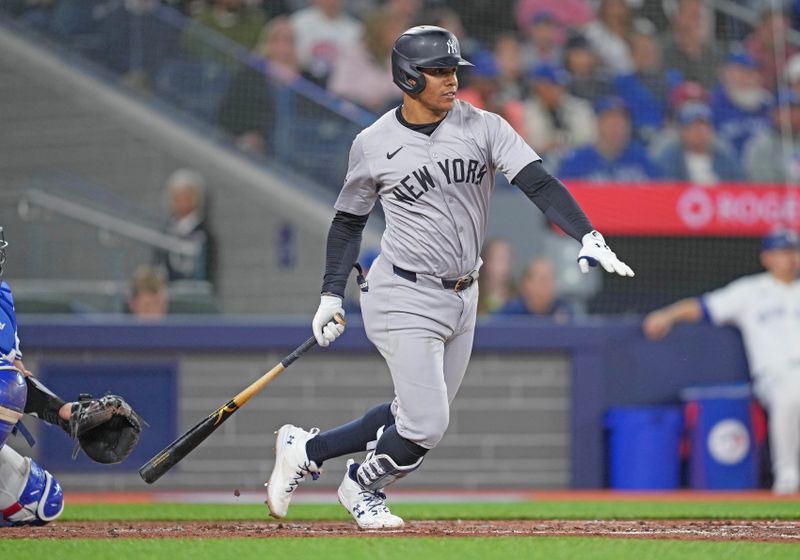 Apr 17, 2024; Toronto, Ontario, CAN; New York Yankees right fielder Juan Soto (22) hits a single against the Toronto Blue Jays during the third inning at Rogers Centre. Mandatory Credit: Nick Turchiaro-USA TODAY Sports