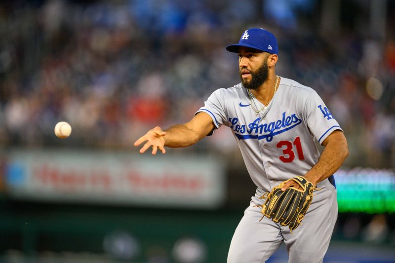 Sep 8, 2023; Washington, District of Columbia, USA; Los Angeles Dodgers shortstop Amed Rosario (31) tosses the ball to first base during the first inning against the Washington Nationals at Nationals Park. Mandatory Credit: Reggie Hildred-USA TODAY Sports