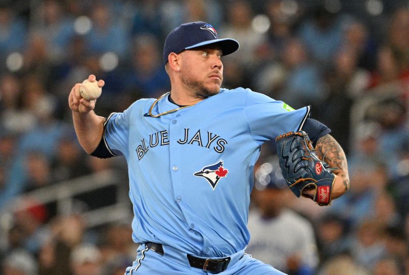 Apr 29, 2024; Toronto, Ontario, CAN;  Toronto Blue Jays starting pitcher Yariel Rodriguez (29) delivers a pitch against the Kansas City Royals in the first inning at Rogers Centre. Mandatory Credit: Dan Hamilton-USA TODAY Sports