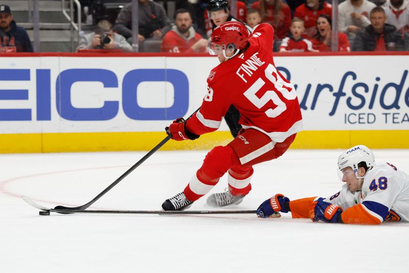 Dec 16, 2025; Detroit, Michigan, USA;  Detroit Red Wings center Emmitt Finnie (58) skates with the puck defended by New York Islanders defenseman Matthew Schaefer (48) in the second period at Little Caesars Arena. Mandatory Credit: Rick Osentoski-Imagn Images