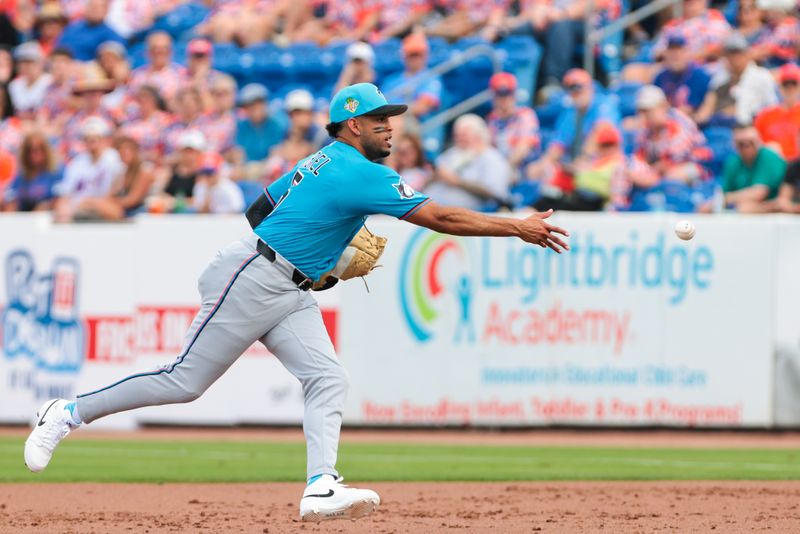 Feb 21, 2026; Port St. Lucie, Florida, USA; Miami Marlins first baseman Christopher Morel (5) tosses the ball to relief pitcher Tyler Phillips (not pictured) to retire New York Mets first baseman Jose Rojas (not pictured) during the third inning at Clover Park. Mandatory Credit: Sam Navarro-Imagn Images