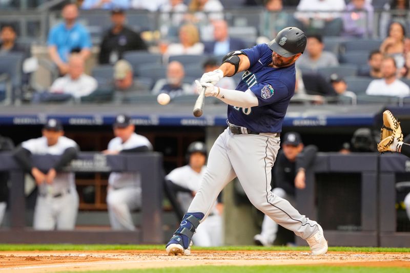 Jun 22, 2023; Bronx, New York, USA; Seattle Mariners designated hitter Mike Ford (20) hits a sacrifice fly ball against the New York Yankees during the first inning at Yankee Stadium. Mandatory Credit: Gregory Fisher-USA TODAY Sports