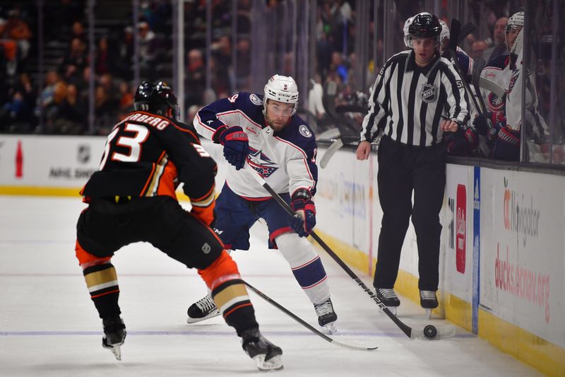 Feb 21, 2024; Anaheim, California, USA; Columbus Blue Jackets defenseman Ivan Provorov (9) moves the puck against Anaheim Ducks right wing Jakob Silfverberg (33) during the second period at Honda Center. Mandatory Credit: Gary A. Vasquez-USA TODAY Sports