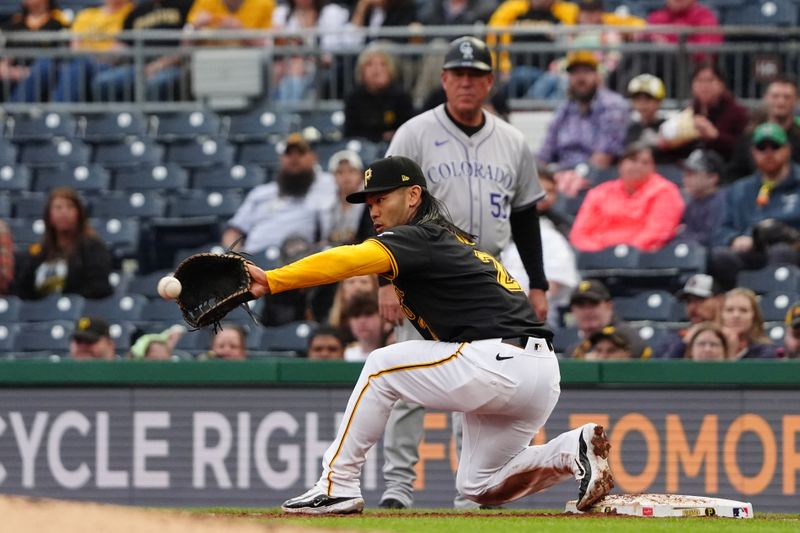 May 4, 2024; Pittsburgh, Pennsylvania, USA; Pittsburgh Pirates first baseman Connor Joe (2) catches a throw to record an out against Colorado Rockies left fielder Jordan Beck (not pictured) during the third inning at PNC Park. Mandatory Credit: Gregory Fisher-USA TODAY Sports