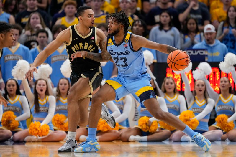 Nov 19, 2024; Milwaukee, Wisconsin, USA;  Marquette Golden Eagles guard Stevie Mitchell (4) drives towards the basket against Purdue Boilermakers forward Trey Kaufman-Renn (4) during the first half at Fiserv Forum. Mandatory Credit: Jeff Hanisch-Imagn Images
