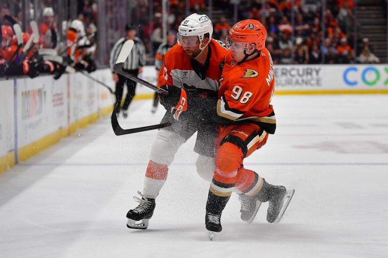 Mar 18, 2026; Anaheim, California, USA; Philadelphia Flyers center Luke Glendening (41) and Anaheim Ducks defenseman Pavel Mintyukov (98) play for the puck during the third period at Honda Center. Mandatory Credit: Gary A. Vasquez-Imagn Images