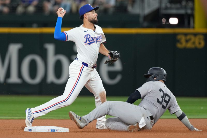 Sep 3, 2024; Arlington, Texas, USA; Texas Rangers short stop Jonathan Ornelas (21) forces out New York Yankees catcher Jose Trevino (39) during the fifth inning at Globe Life Field. Mandatory Credit: Jim Cowsert-Imagn Images