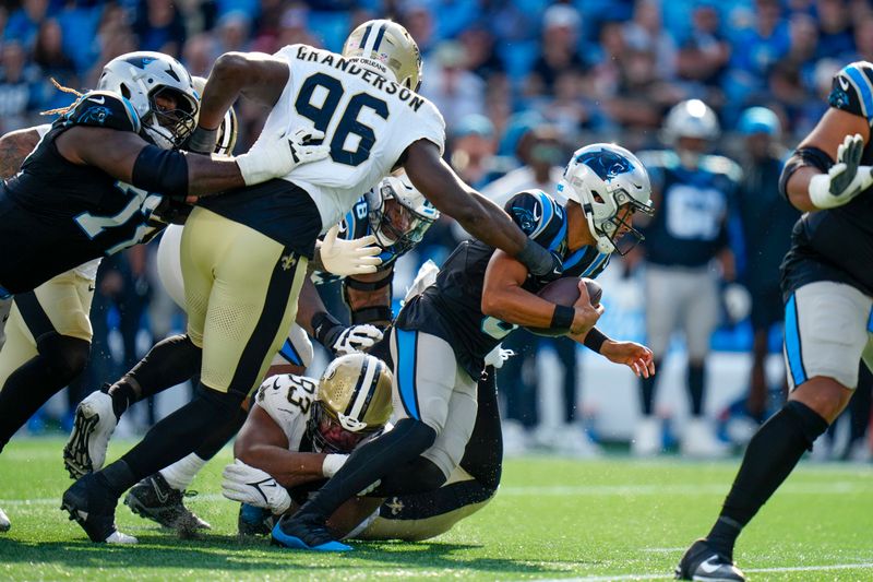 Carolina Panthers quarterback Bryce Young is sacked by New Orleans Saints defensive end Carl Granderson (96) and defensive tackle Nathan Shepherd (93) during the first half of an NFL football game Sunday, Nov. 3, 2024, in Charlotte, N.C. (AP Photo/Rusty Jones)