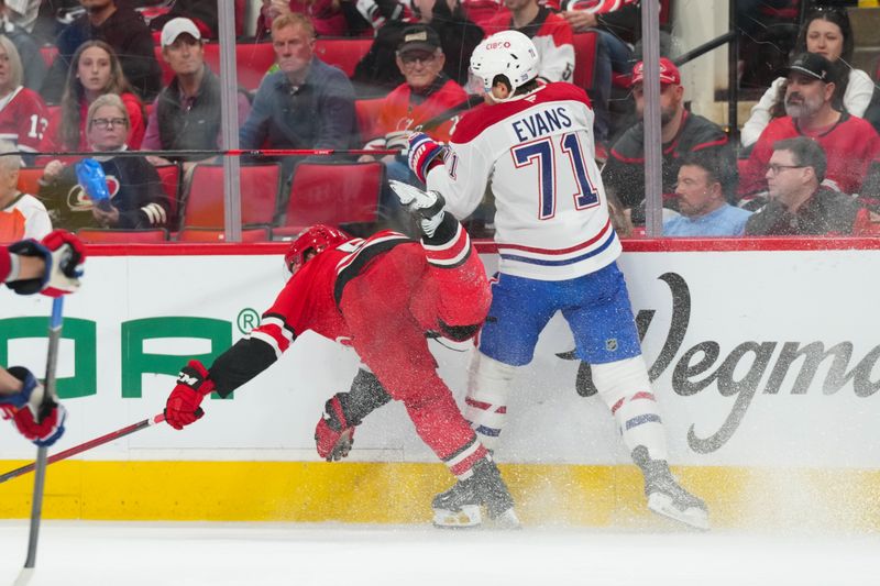 Mar 29, 2026; Raleigh, North Carolina, USA;  Carolina Hurricanes right wing Jackson Blake (53) is checked by Montreal Canadiens center Jake Evans (71) during the second period at Lenovo Center. Mandatory Credit: James Guillory-Imagn Images