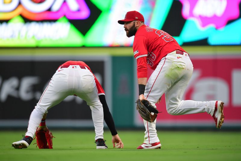 August 16, 2024; Anaheim, California, USA; Los Angeles Angels right fielder Mickey Moniak (16) and second baseman Michael Stefanic (38) mishandle the single of Atlanta Braves designated hitter Marcell Ozuna (20) during the fourth inning at Angel Stadium. Mandatory Credit: Gary A. Vasquez-USA TODAY Sports