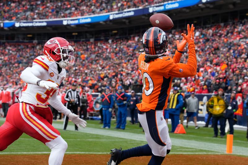 Denver Broncos wide receiver Jerry Jeudy (10) catches a touchdown pass as Kansas City Chiefs cornerback Jaylen Watson defends during the first half of an NFL football game Sunday, Oct. 29, 2023, in Denver. (AP Photo/David Zalubowski)