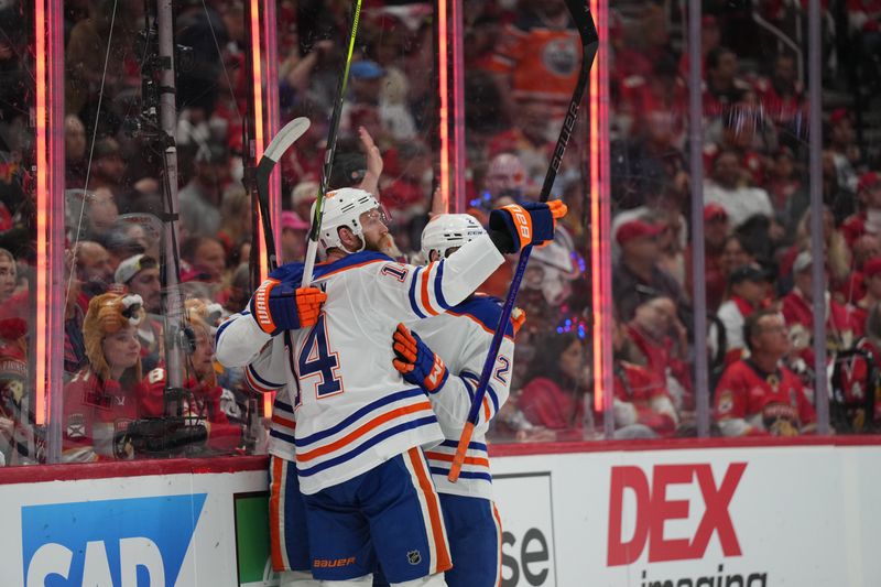 Jun 10, 2024; Sunrise, Florida, USA; Edmonton Oilers defenseman Mattias Ekholm (14) celebrates scoring against the Florida Panthers during the first period in game two of the 2024 Stanley Cup Final at Amerant Bank Arena. Mandatory Credit: Jim Rassol-USA TODAY Sports