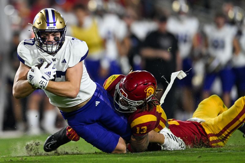 Nov 4, 2023; Los Angeles, California, USA; USC Trojans linebacker Mason Cobb (13) tackles Washington Huskies tight end Jack Westover (37) during the third quarter at United Airlines Field at Los Angeles Memorial Coliseum. Mandatory Credit: Jonathan Hui-USA TODAY Sports