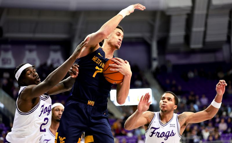 Feb 12, 2024; Fort Worth, Texas, USA;  West Virginia Mountaineers center Jesse Edwards (7) grabs the ball away from TCU Horned Frogs forward Emanuel Miller (2) during the second half at Ed and Rae Schollmaier Arena. Mandatory Credit: Kevin Jairaj-USA TODAY Sports